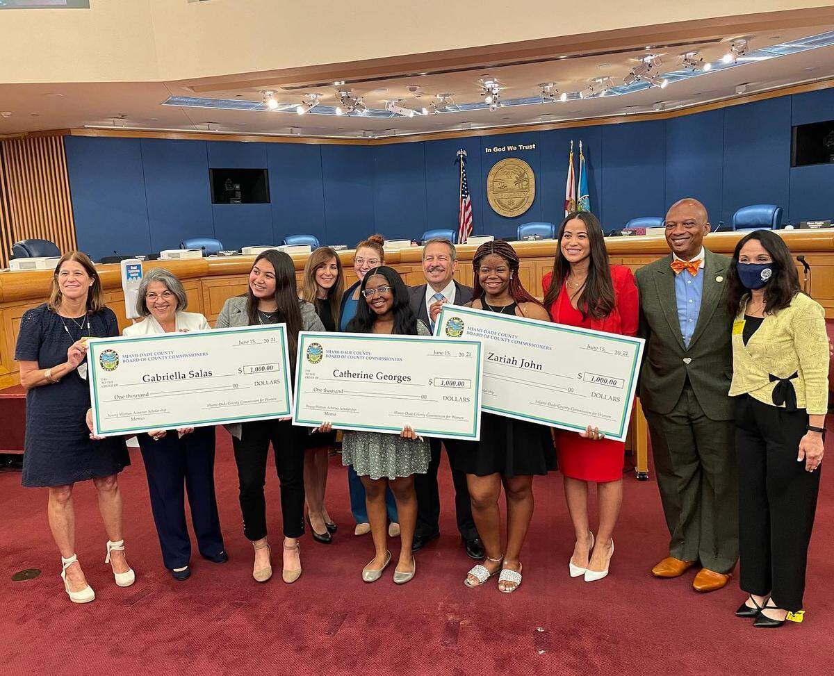 From left: Principal Silvia Tarafa of YWPA; Miami-Dade Mayor Daniella Levine Cava; Gabriella Salas; First Vice Chair of the Commission for Women Monica Interian; Executive Director of the commission Monica Skoko Rodriguez; Catherine Georges; County Commission Chairman Jose “Pepe” Diaz; Zariah John; County Commissioner Danielle Cohen Higgins; Vice County Commission Chairman Oliver Gilbert; and Lead Teacher of YWPA Rose Milian.