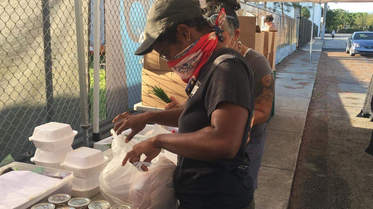 A packer prepares farmers market items for delivery for the Urban Oasis Project, a consortium of South Florida farmers and farmers market vendors.