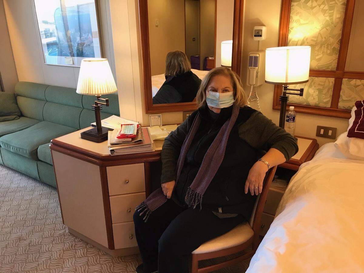 Crystal River, Florida resident Gay Courter in her Diamond Princess cabin with a mask. All passengers are asked to wear a mask when leaving their cabin on the quarantined ship