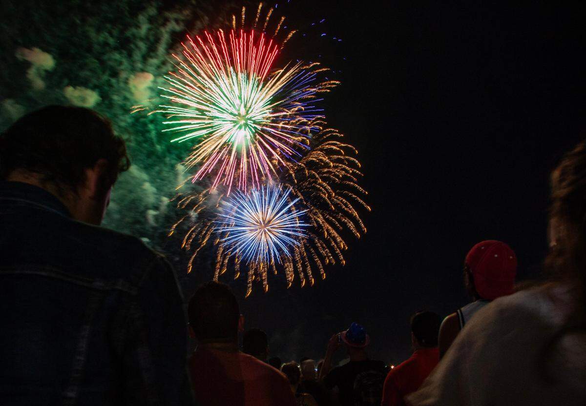 Attendees watch the fireworks during the Fourth of July Bayfront Park Celebration at Bayfront Park on Tuesday, July 4, 2023 in Miami, Fla.