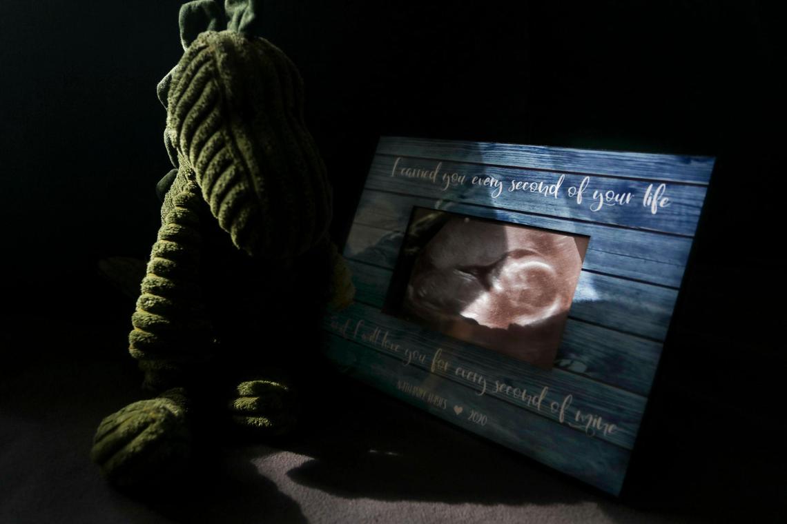 A dinosaur and a sonogram of Nathaniel on display at the Tallafuss family’s Oveido home on Monday, Feb. 21, 2022. Danielle Tallafus and her husband Jason Tallafuss, decided to terminate her pregnancy at 22 weeks after learning that Nathaniel would have been born with hypoplastic left heart syndrome to protect their child from the toll his condition would take on his life. “I carried you every second of your life and I will love you for every second of mine,” reads the frame.