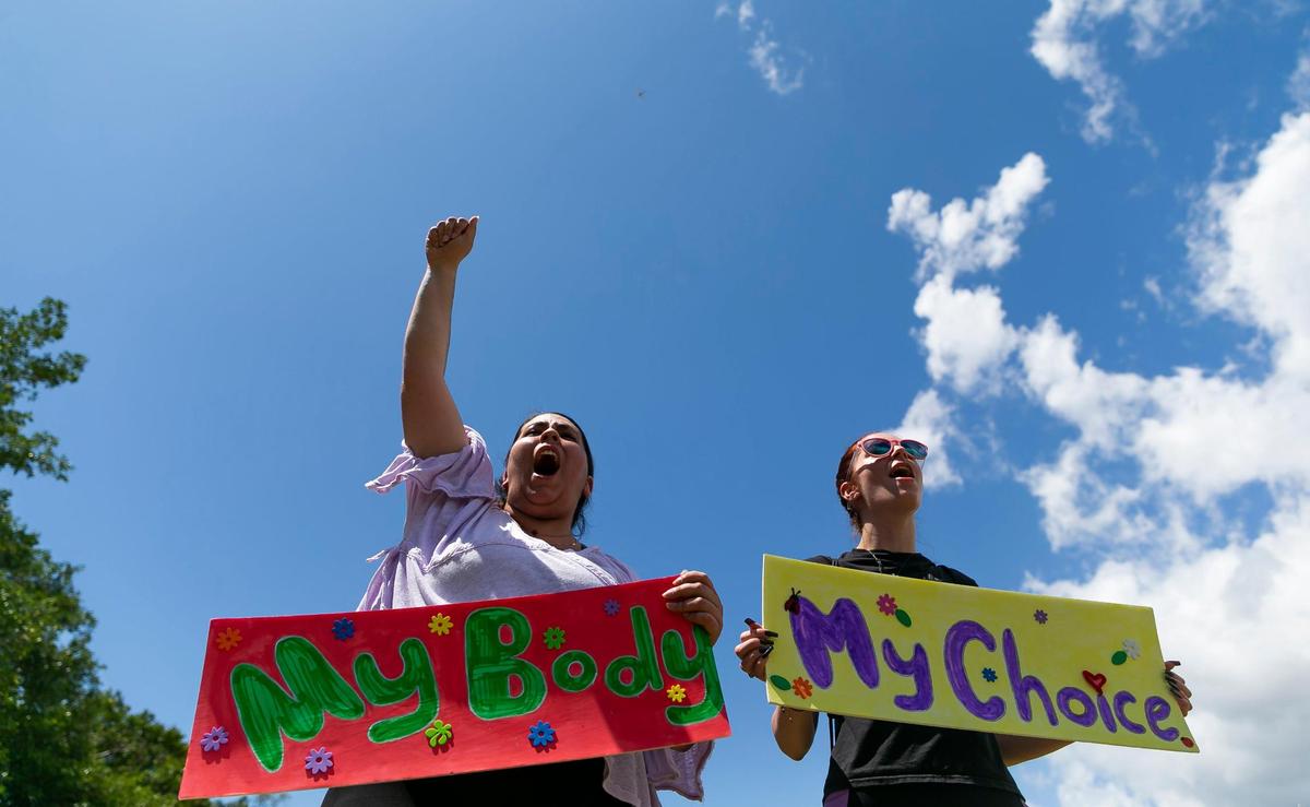 Ayslin Zuniga, left, and Isabella Blanco, both from South Miami, hold signs and chant while attending the “Bans Off Our Bodies” rally at Ives Estates Park in Miami, Florida on Saturday, May 14, 2022. The rally was held in opposition of the leaked draft opinion from SCOTUS which aims to overturn Roe v. Wade, removing women’s constitutional right to an abortion.