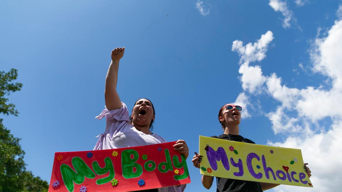 Ayslin Zuniga, left, and Isabella Blanco, both from South Miami, hold signs and chant while attending the “Bans Off Our Bodies” rally at Ives Estates Park in Miami, Florida on Saturday, May 14, 2022. The rally was held in opposition of the leaked draft opinion from SCOTUS which aims to overturn Roe v. Wade, removing women’s constitutional right to an abortion.
