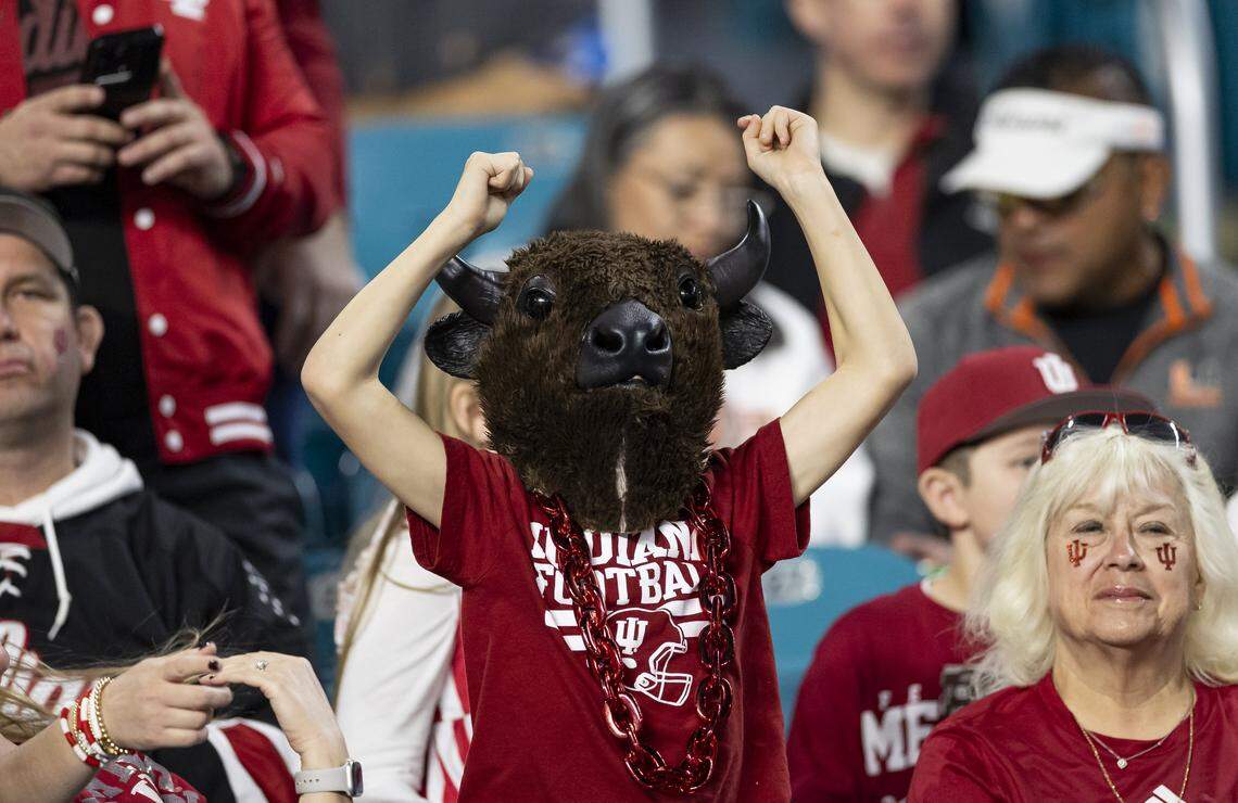 An Indiana Hoosiers fan cheers for their team as they warmup before the start of their College Football Playoff National Championship Game against the Miami Hurricanes at Hard Rock Stadium on Monday, Jan. 19, 2026, in Miami Gardens, Fla.