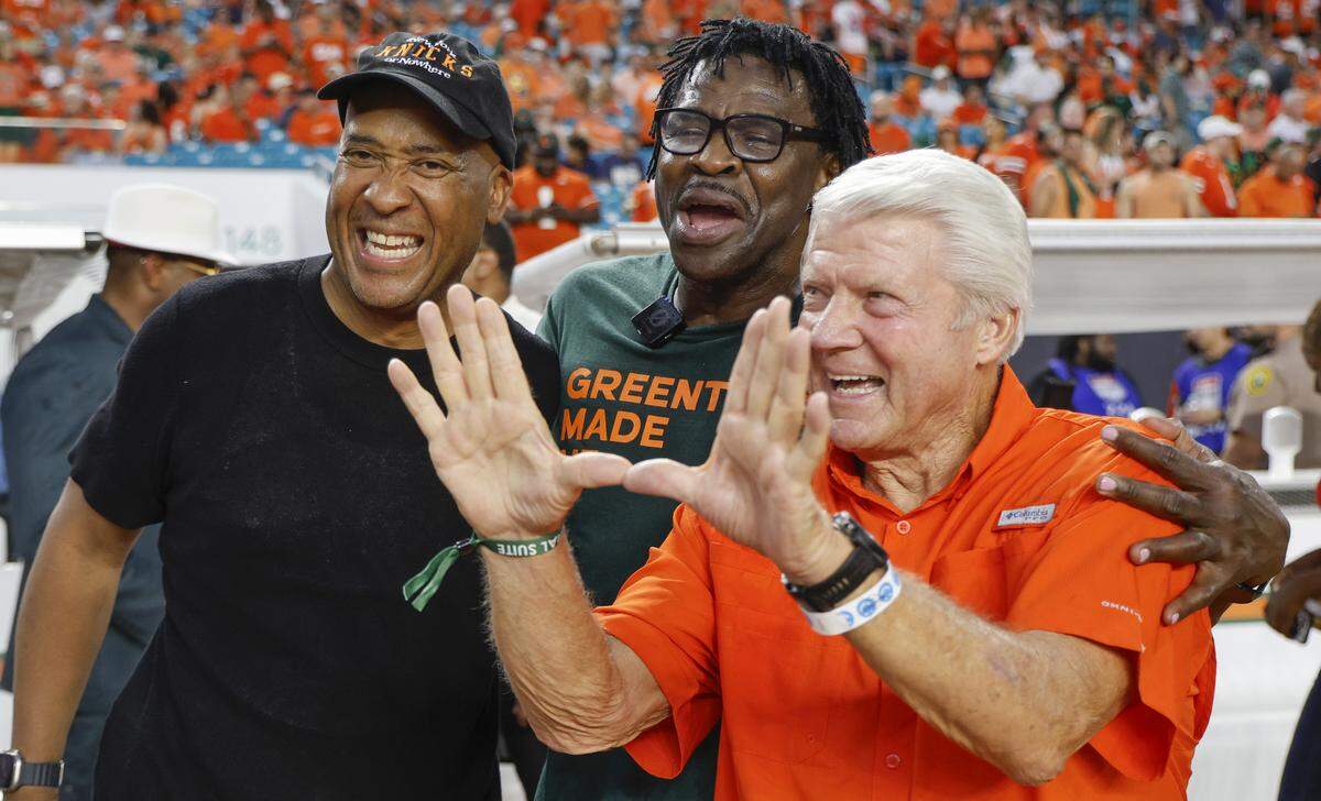 William Wesley, (AKA World Wide Wes) with former wide receiver Michael Irving and Jimmy Johnson flashing the U, in the bench area before the game against the Notre Dame Fighting Irish of an NCAA football game at Hard Rock Stadium in Miami Gardens, Florida, on Sunday, August 31, 2025. 
