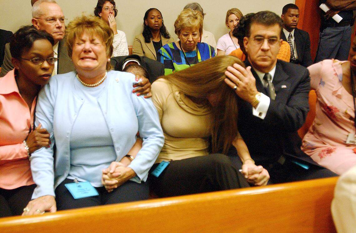 Victim Witness Coordinator Marva Coward, left, supports Yvonne Melendi, the mother of Shannon Melendi, as Shannon’s sister, Monique Melendi, leans on the shoulder of their father, Luis Melendi, as Colvin “Butch” Hinton is pronounced guilty of Shannon’s murder in Decatur Ga., Monday, Sept 19, 2005. Hinton had been accused of abducting Shannon, 19, an Emory sophomore from Miami, after a softball game at the complex where they both worked in March 1994. Her body has never been found. (AP Photo/Renee’ Hannans Henry, Pool)