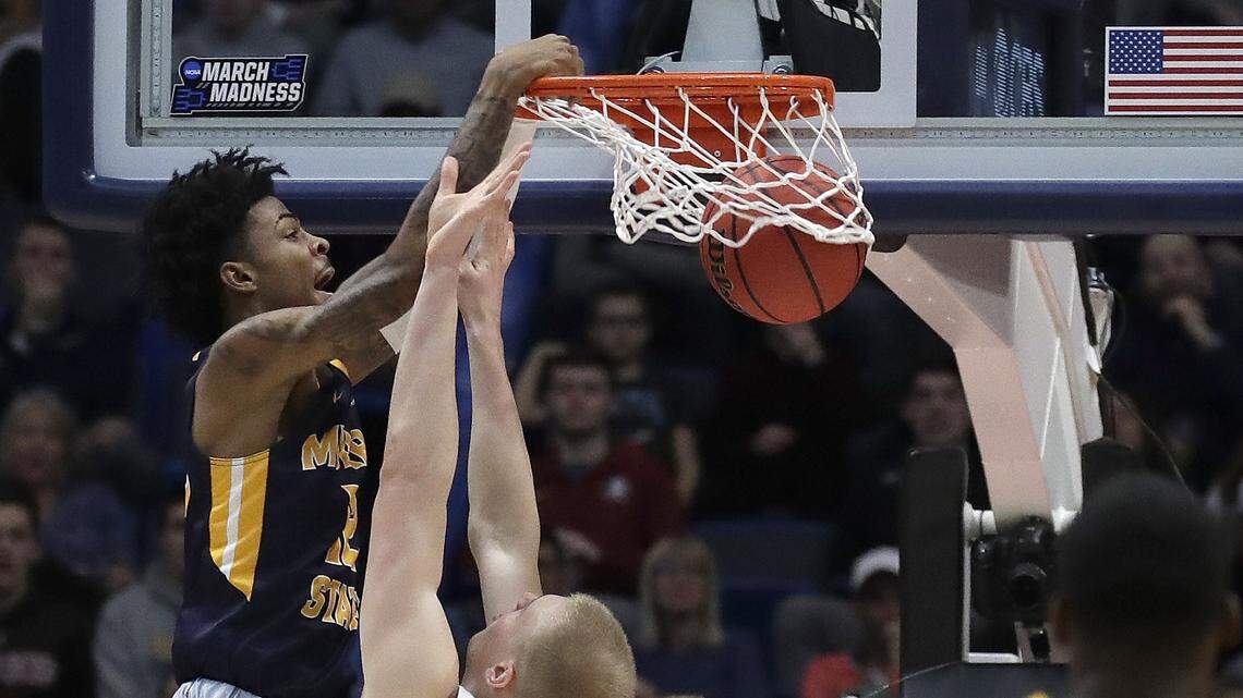 Murray State’s Ja Morant, left, dunks over Marquette’s Joey Hauser (22) during the second half of a first round men’s college basketball game in the NCAA Tournament, Thursday, March 21, 2019, in Hartford, Conn.