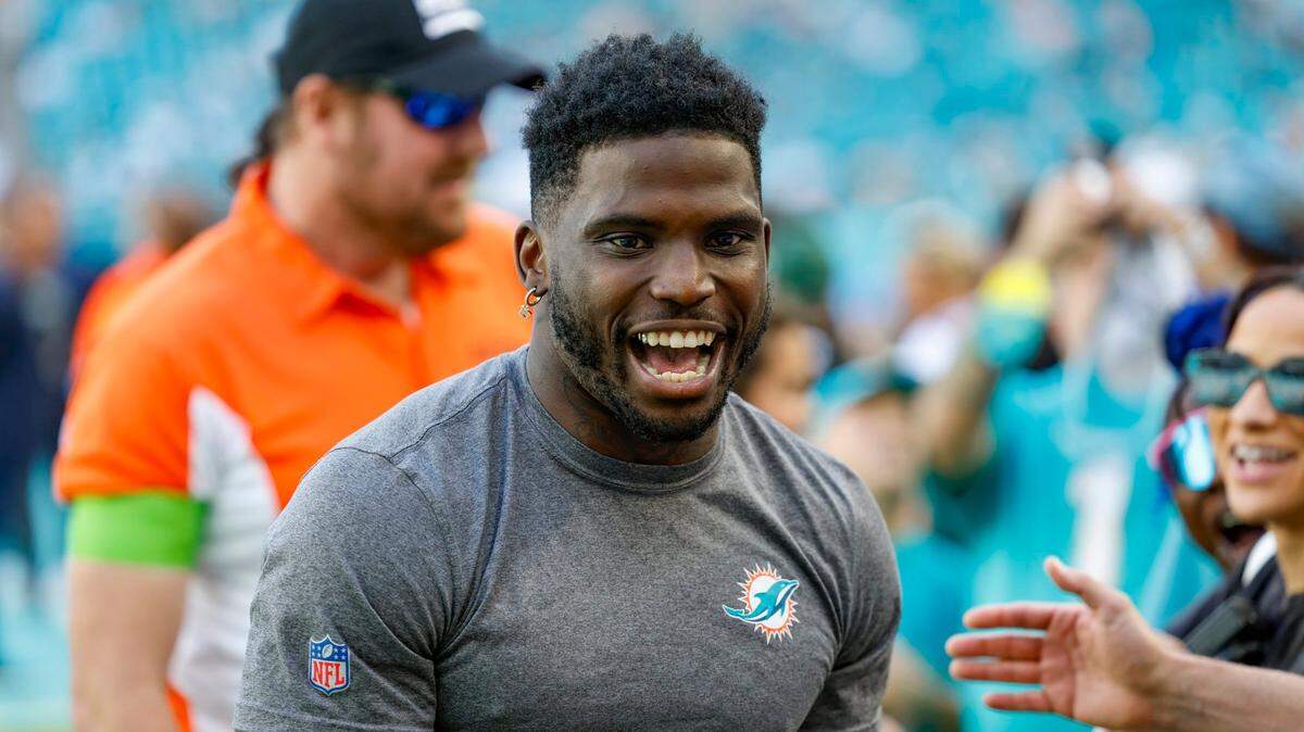 An injured Miami Dolphins wide receiver Tyreek Hill (10) visits with fans before the start of the game against the New York Jets at Hard Rock Stadium in Miami Gardens, Florida on Sunday, December 17, 2023.