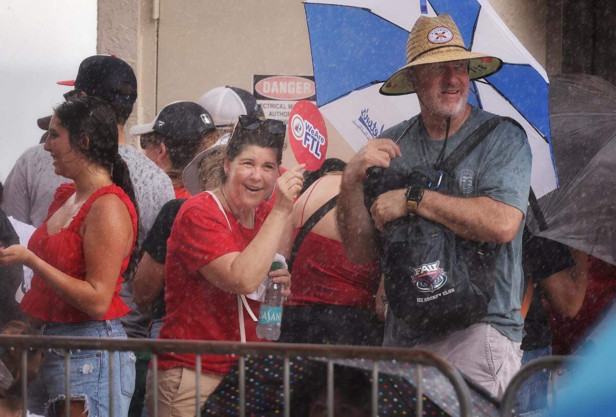 The rain didn’t stop Panthers fans as they huddled under shelter before the Stanley Cup victory parade at Fort Lauderdale Beach on Tuesday, June 30, 2024 in Fort Lauderdale.&nbsp;