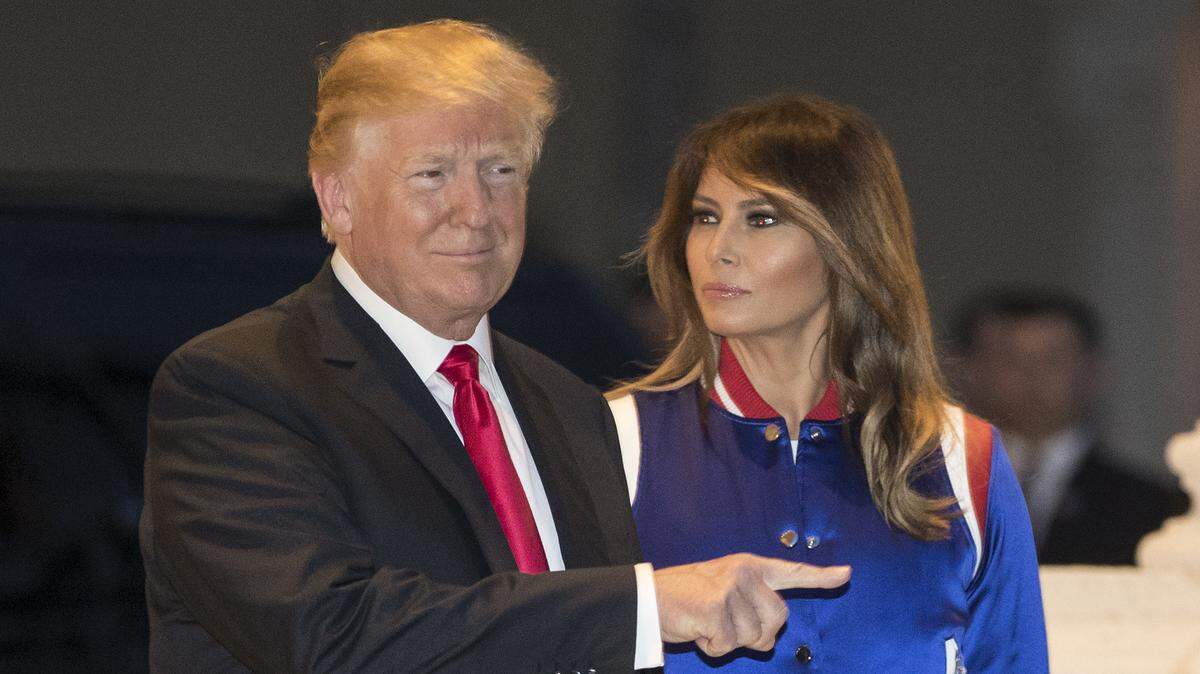 President Donald Trump and first lady Melania view the Florida Atlantic University marching band at Trump International Golf Club in West Palm Beach, Sunday, Feb. 4, 2018, as they arrive for a Super Bowl party.