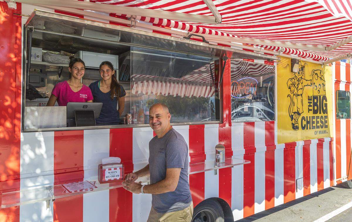 Owner Felipe Grabiel and his daughters Carolina (left) and Natalia Grabiel, at their Wall's Old Fashioned Ice cream food truck that has opened on the property of The Big Cheese pizzeria in South Miami, on Tuesday, December 30, 2025.
