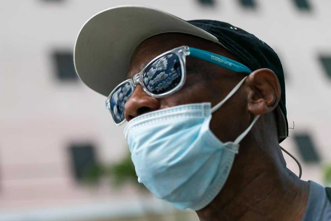 Curtis Larue Johnson, 61, walks with his bike near the Miami Rescue Mission Clinic as concerns over COVID-19 continue to spread through South Florida.