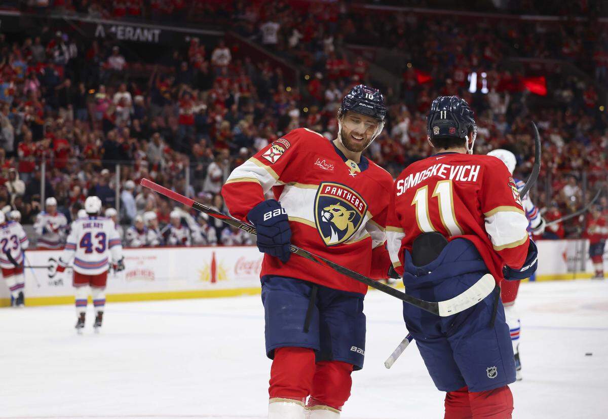 Florida Panthers left wing A.J. Greer (10) taps right wing MacKie Samoskevich (11) on the backside after Samoskevich scored a goal during the first period of a game against the New York Rangers on Monday, April 13, 2026, at Amerant Bank Arena in Miami, Fla.