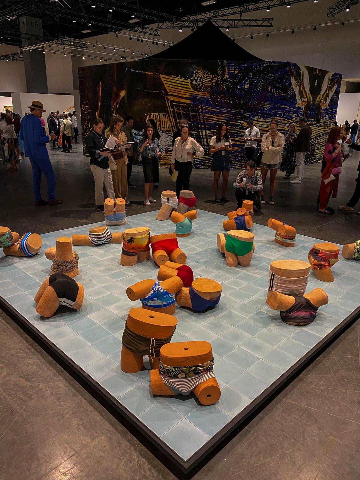 Miami Beach, FL- November 29, 2022 - Jonathas de Andrade’s Lost and Found, 25 sculptures of burnt clay and swimwear, at the Meridians sector during the Art Basel VIP opening day. At the Miami Beach Convention Center.