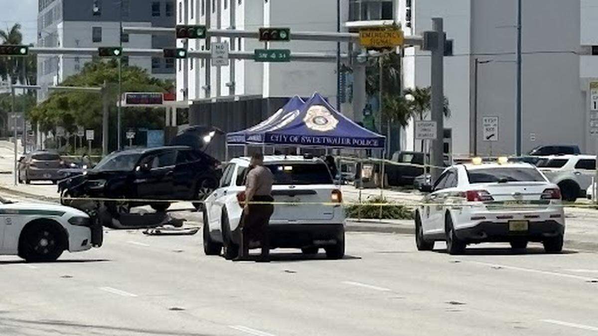 Scene of the car crash after a man, suspected of shooting a woman to death, turned the gun on himself near Southwest 107th Avenue and Third Street