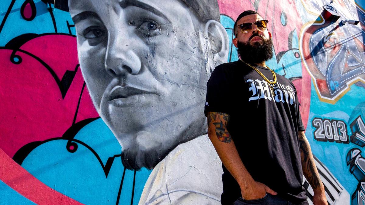 Graffiti artist Disem in front of a mural he created of former Miami Marlins player José Fernández. He painted it as part of a series commissioned by former MLB player Yunel Escobar.