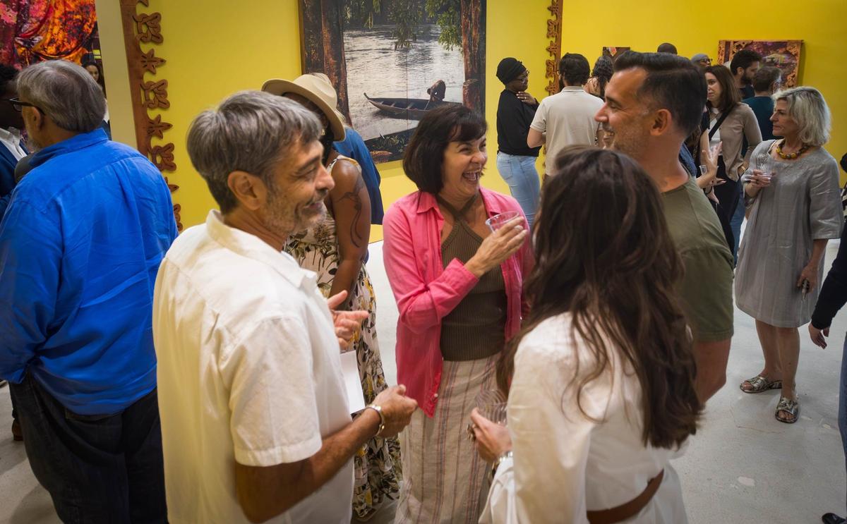 Guests socialize at Cornelius Tulloch’s solo show opening party at the Andrew Reed Gallery on Thursday, July 11, 2024 in Miami, Fla.