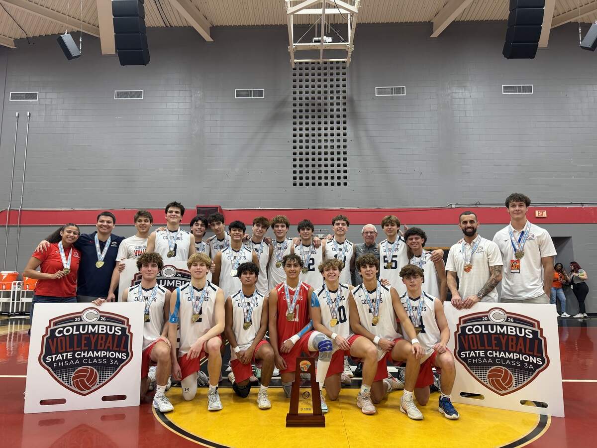 The Columbus volleyball team celebrates after winning their its first state championship following a 3-set win over Horizon High on Saturday at Polk State College in Winter Haven, Fla.