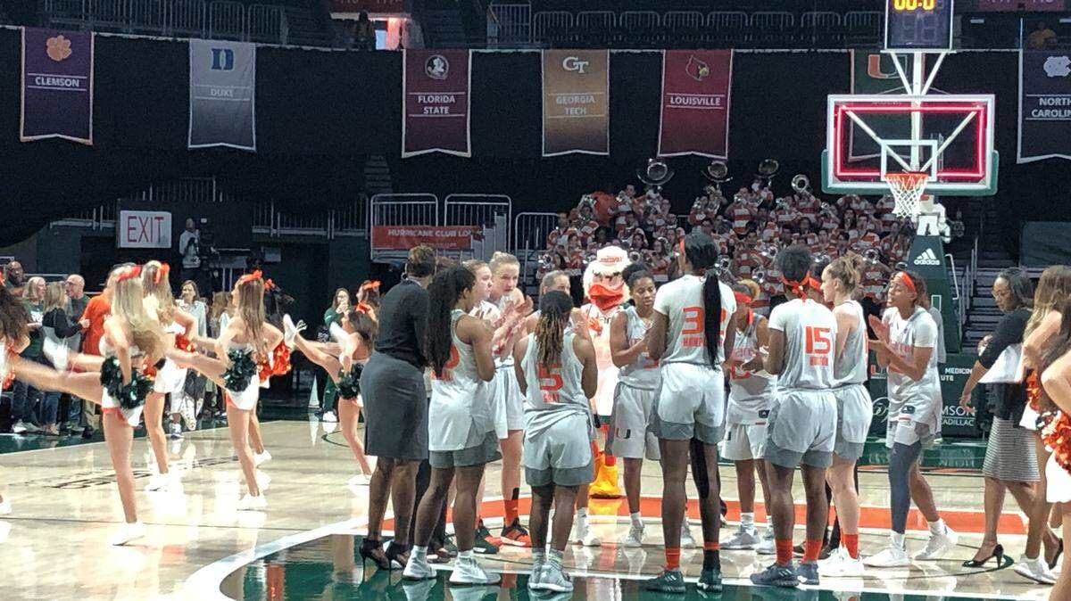 The University of Miami women’s basketball team celebrates at midcourt after beating North Carolina 76-68 at the Watsco Center on Sunday.
