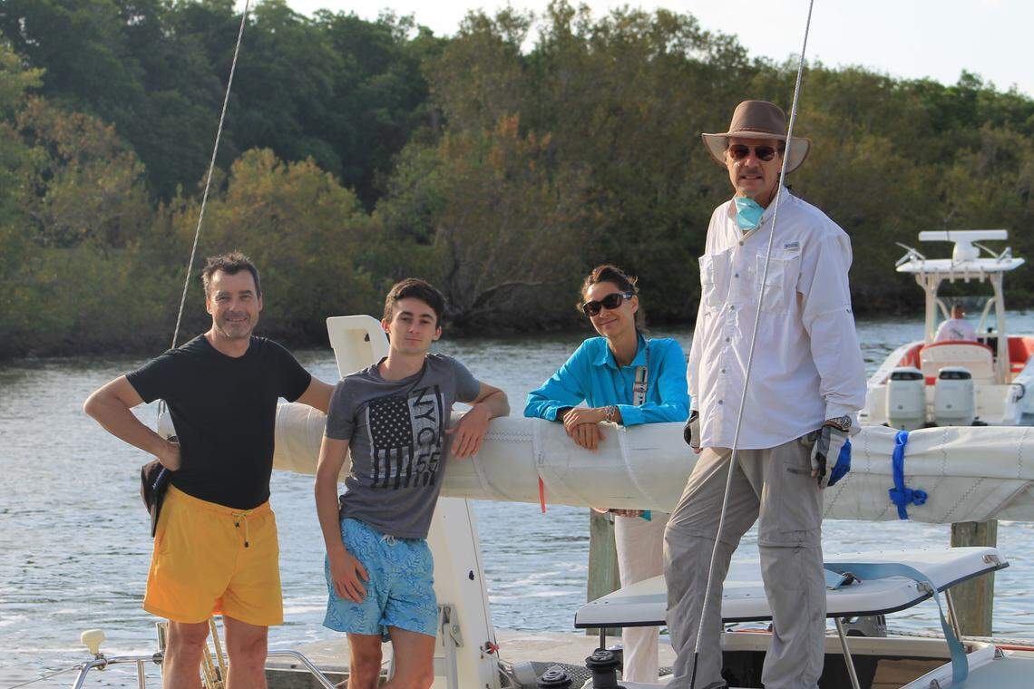 Daniel, Anne and Vincent Roustit and Pierre Berthier gather on the deck of Berthier’s sailboat on Wednesday, April 29, 2020, at Blackpoint Marina in South Miami-Dade County.