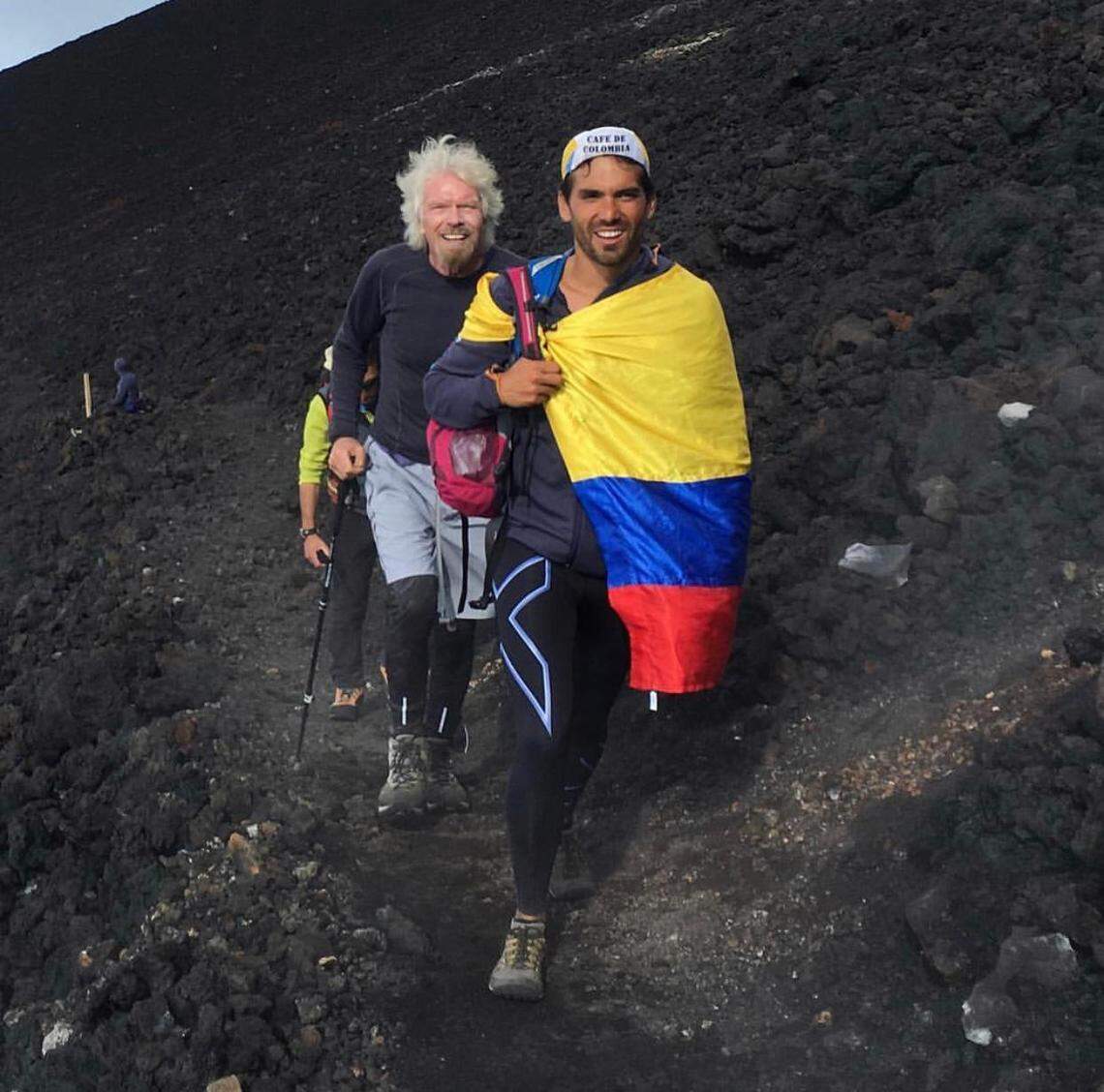 Bruno Ocampo (foreground) and Richard Branson on a hike in France. Ocampo is helping organize an aid concert for Venezuela that Branson — the billionaire founder of the Virgin Group — is backing.
