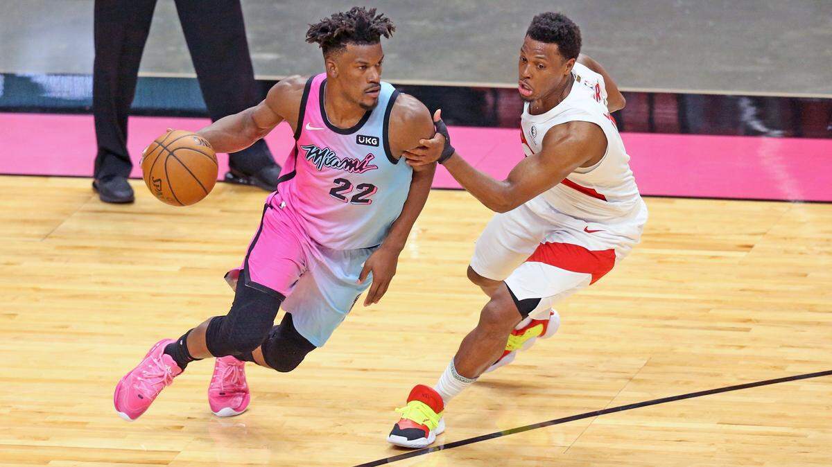 Miami Heat forward Jimmy Butler (22) drives the ball as Toronto Raptors guard Kyle Lowry (7) defends in the fourth quarter at AmericanAirlines Arena on Wednesday, February 24, 2021.