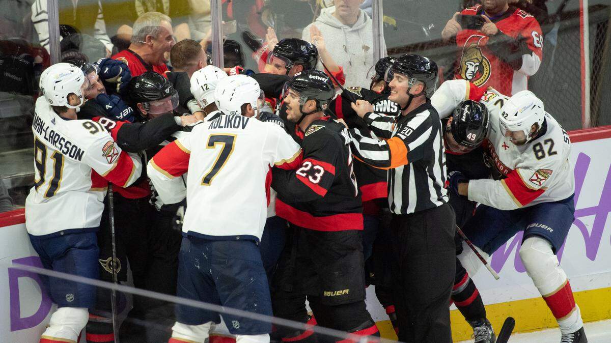 Nov 27 2023; Ottawa, Ontario, CAN; The entire Florida Panthers line including defensemen Oliver Ekman-Larsson (91) and Dmitry Kulikov (7) fight with the Ottawa Senators line which includes defenseman Travis Hamonic (23) and defenseman Erik Brannstrom (26) in the third period at the Canadian Tire Centre.