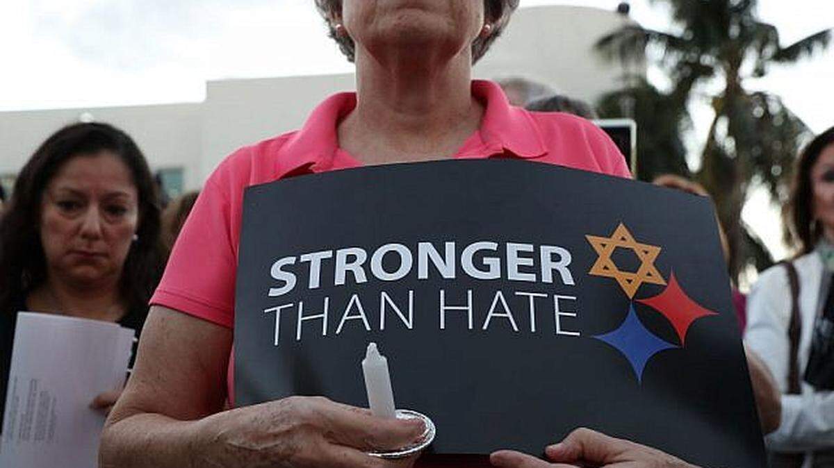 A woman joins others for a Community-Wide Solidarity Vigil at the Holocaust Memorial Miami Beach to remember the victims of a mass shooting at a Pittsburgh temple in October 2018.