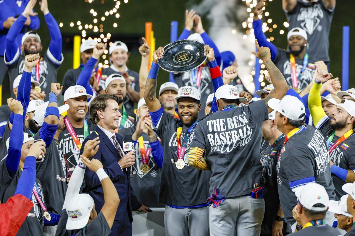 Venezuela third baseman Maikel Garcia (11) celebrates with teammates after Venezuela defeats United States in the final game of the 2026 World Baseball Classic at loanDepot park on Tuesday, March 17, 2026.
