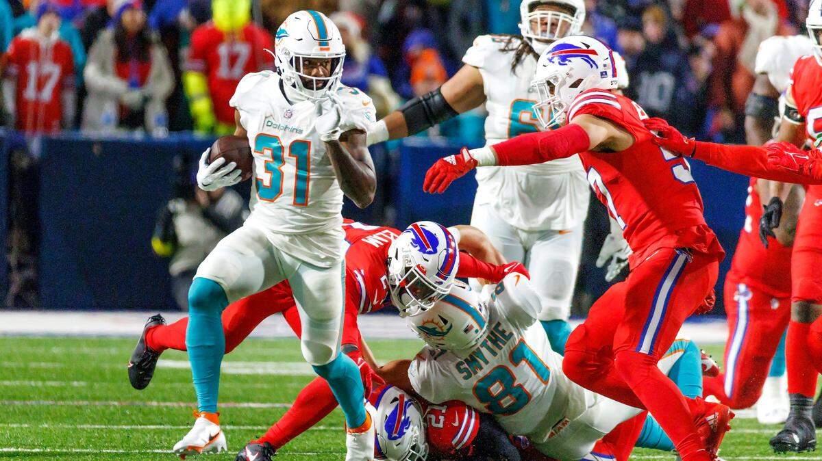 Miami Dolphins running back Raheem Mostert (31) runs the football during first quarter of an NFL football game against the Buffalo Bills at Highmark Stadium on Saturday, December 17, 2022 in Orchard Park, New York.