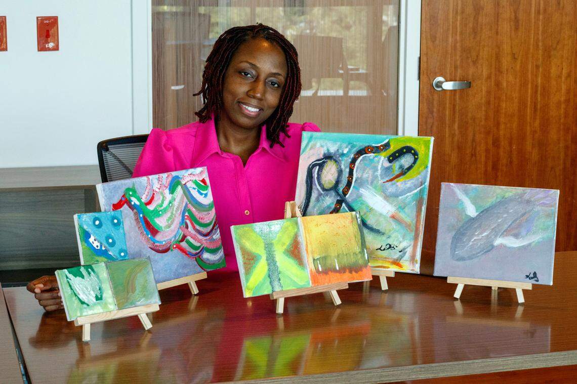 Latoya Simmons, 42, showcases some of the paintings she made while undergoing chemotherapy for breast cancer at the Miami Cancer Institute, part of Baptist Health South Florida.