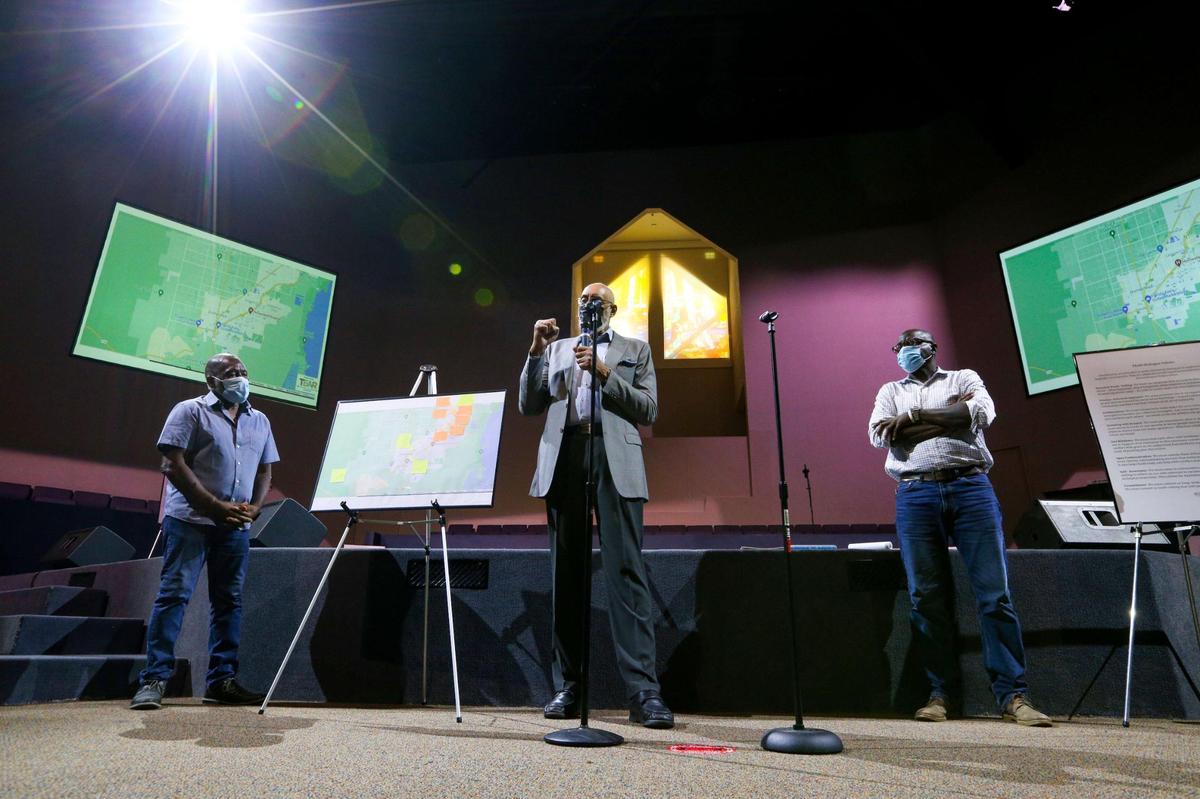 Members of the Steering Committee of Miami-Dade TEAR, Dinizulu Gene Tinnie, center, Dr. Marvin Dunn, left, and Co-chair Guy Forchion, right, address a crowd while discussing three South Florida victims of lynchings: J.B. Harris, William Simmons, and Roy Gaines. The three victims were killed near Homestead, Florida, in the 1920s. The discussion came during a Miami-Dade TEAR Initiative at Sweet Home Missionary Baptist Church in West Perrine, Florida, on Saturday, Nov. 13, 2021.