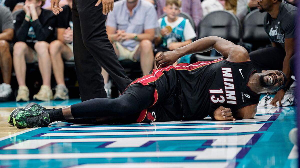 Bam Adebayo #13 of the Miami Heat reacts after a fall in the first half against the Charlotte Hornets during their game at Spectrum Center on April 14, 2026 in Charlotte, North Carolina.