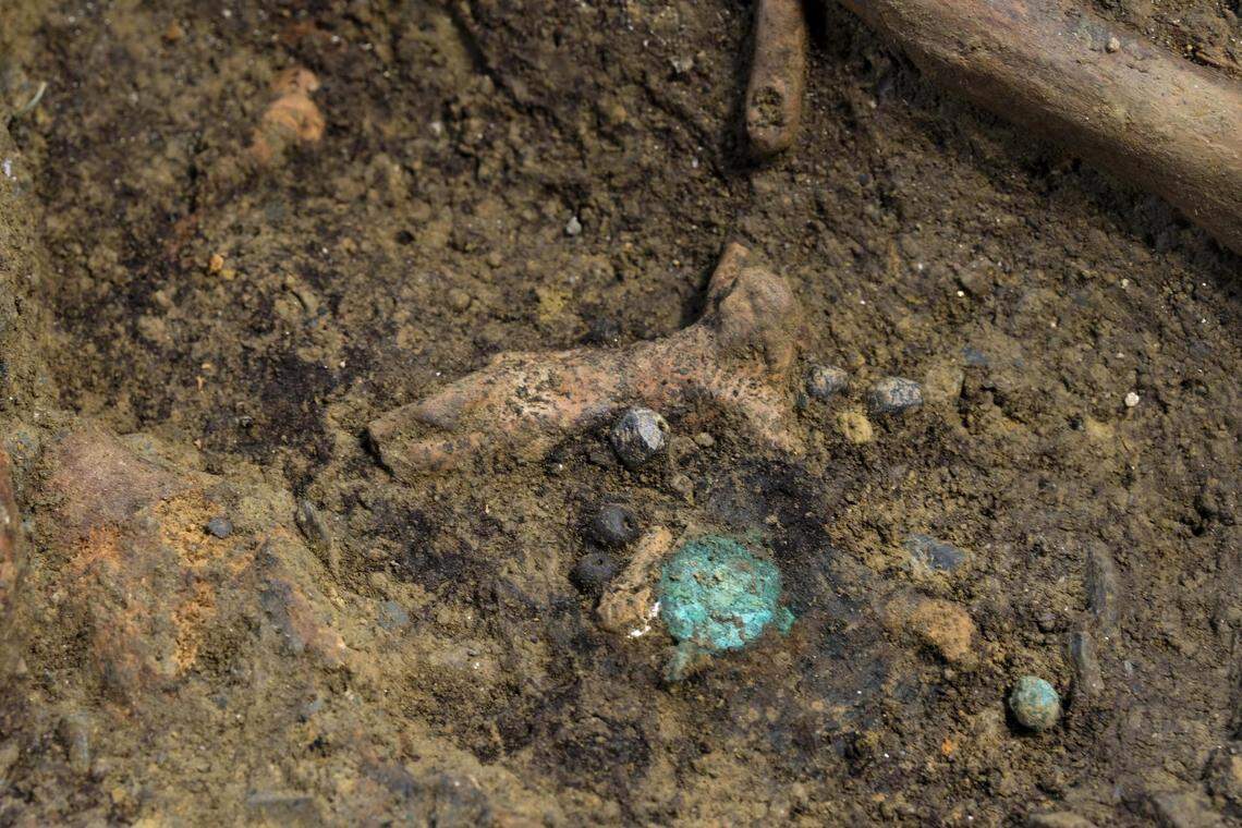 A ceramic crucifix and a copper medal found at the church.