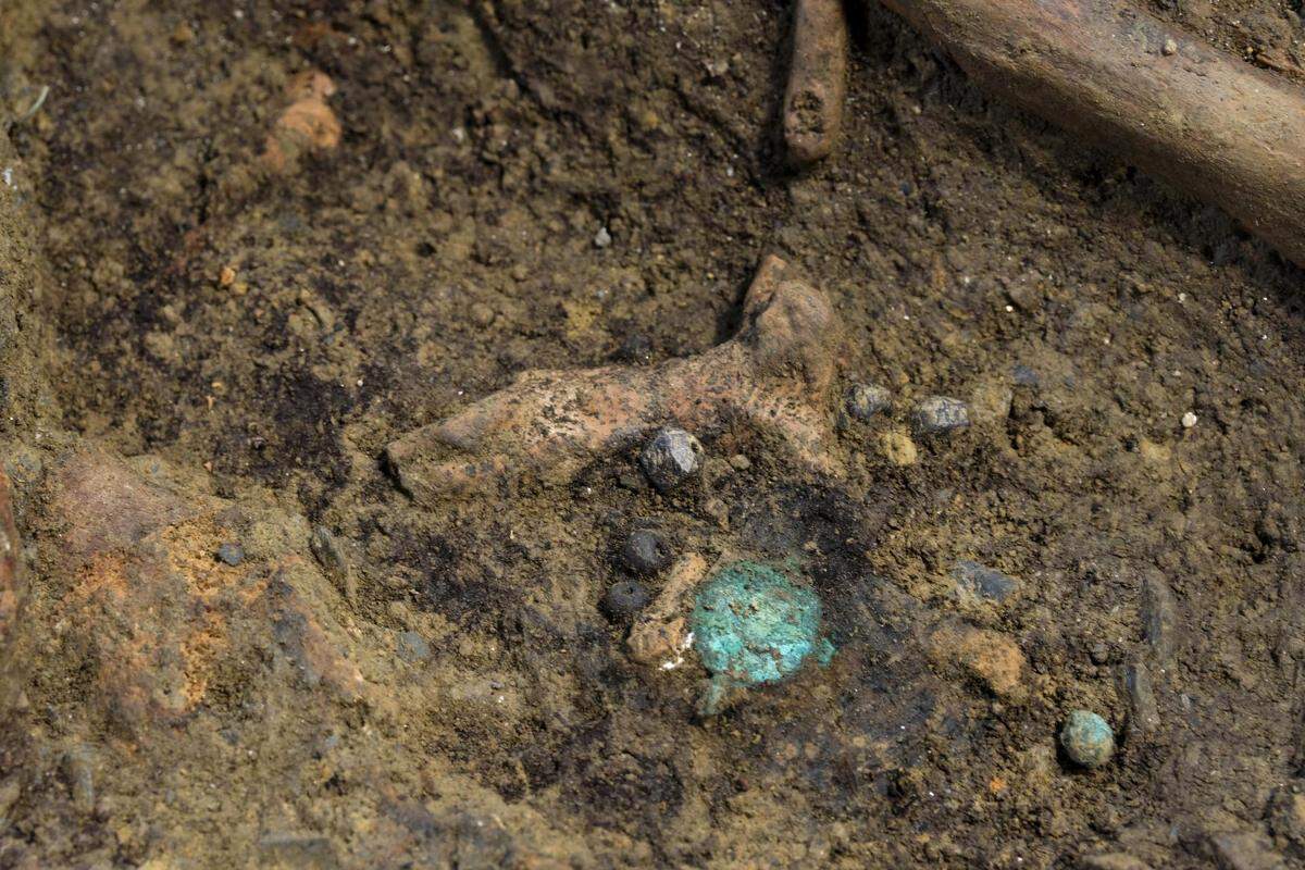 A ceramic crucifix and a copper medal found at the church.