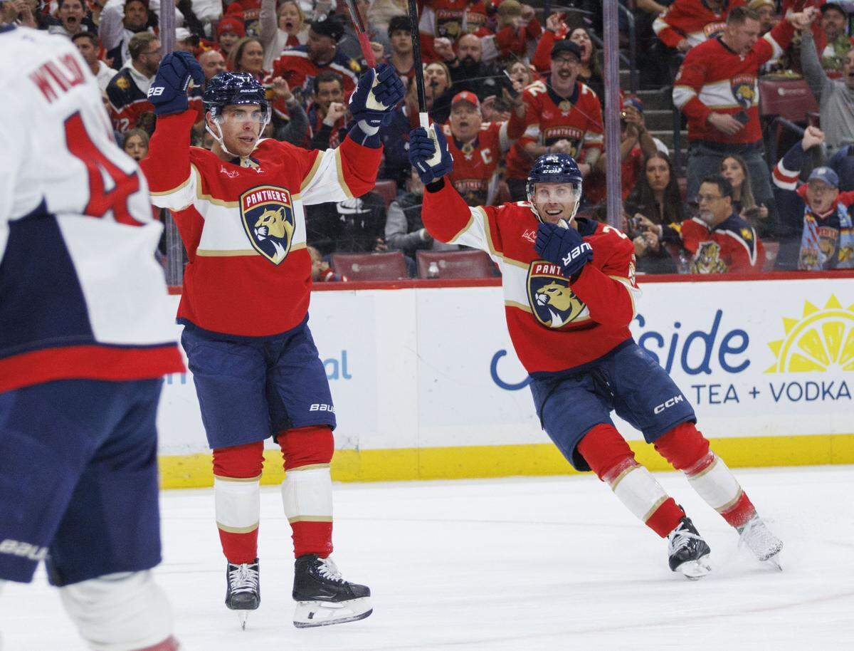 Florida Panthers center Evan Rodrigues (17) reacts to scoring his 100th goal of his NHL career and center Carter Verhaeghe (23) smiles at him during the first period of a game on Thursday, Nov. 13, 2025, at Amerant Bank Arena in Sunrise, Fla.