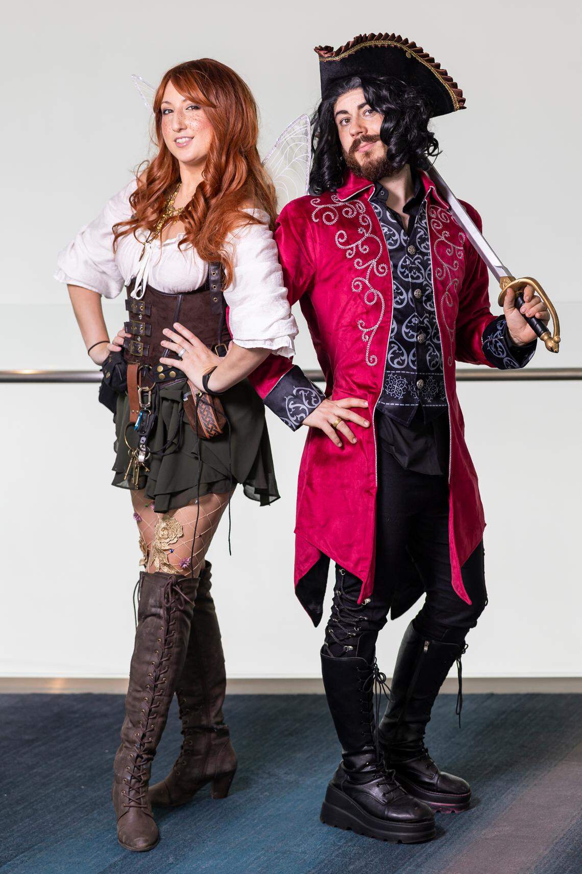 Cosplayers Kali Watson, left, as Zarina, and Danny Black, as Captain Hook, both from the Tinker Bell series.