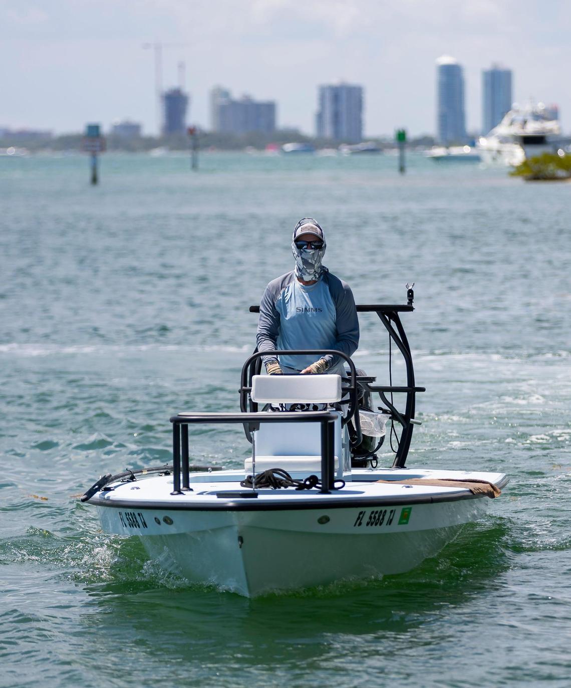 Fishing guide Carl Ball, 58, drives his boat near Crandon Park Marina in Key Biscayne.