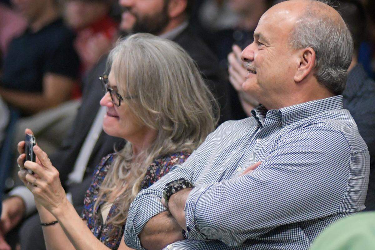 Mabel Alvarez (left) and Walter Alvarez, parents of two-time Olympic medalist Eddy Alvarez, listen as their son speaks during the Columbus Connects Leadership Lecture Series at Columbus High School on Wednesday, Nov. 17, 2021.