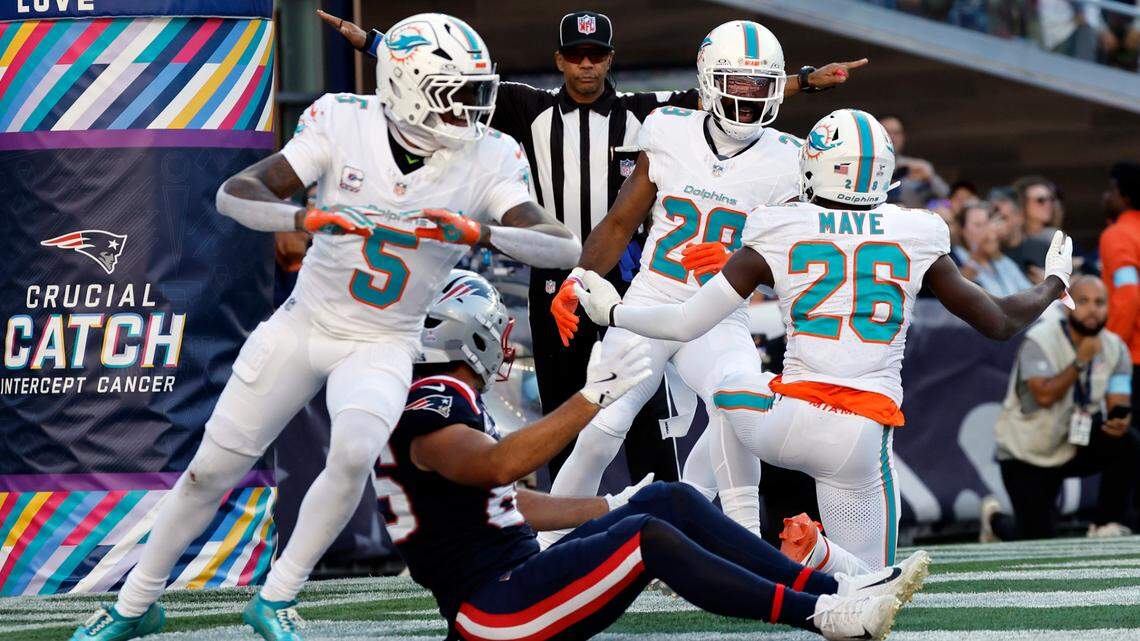 Miami Dolphins cornerback Jalen Ramsey (5), cornerback Kendall Fuller (29) and safety Marcus Maye (26) react after New England Patriots tight end Hunter Henry (85) fails to make the catch in the end zone late in the second half of their NFL football game at Gillette Stadium in Foxborough, Massachusetts on Sunday, October 6, 2024.