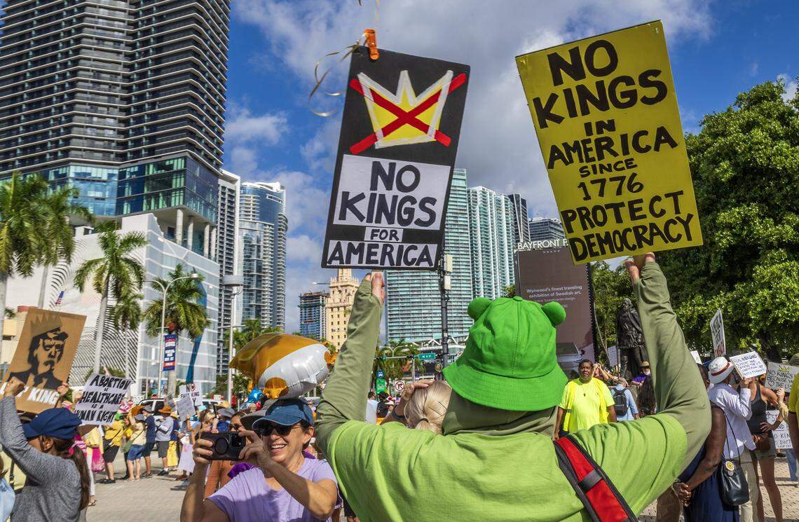 Protesters with signs at the Miami Torch of Friendship in downtown Miami during the ‘No Kings’ anti-Trump protests on Oct. 18, 2025.