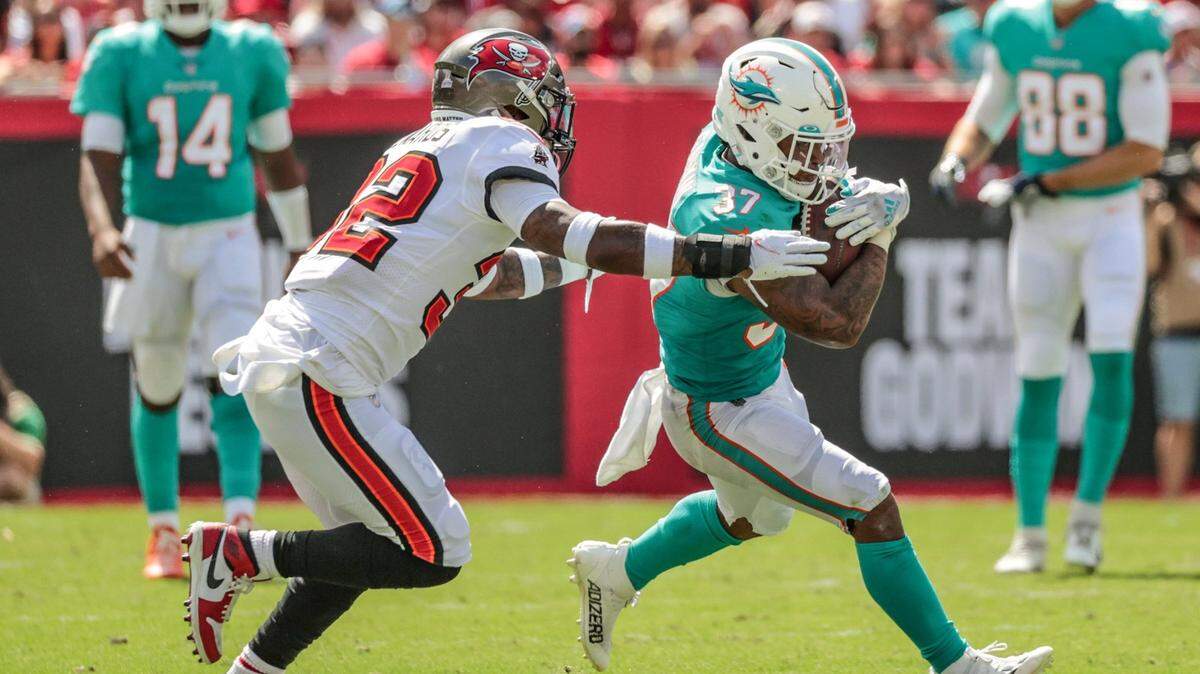 Miami Dolphins running back Myles Gaskin (37) on a pass reception in the first half as Tampa Bay Buccaneers safety Mike Edwards (32) defends at Raymond James Stadium in Tampa on Sunday, October 10, 2021.