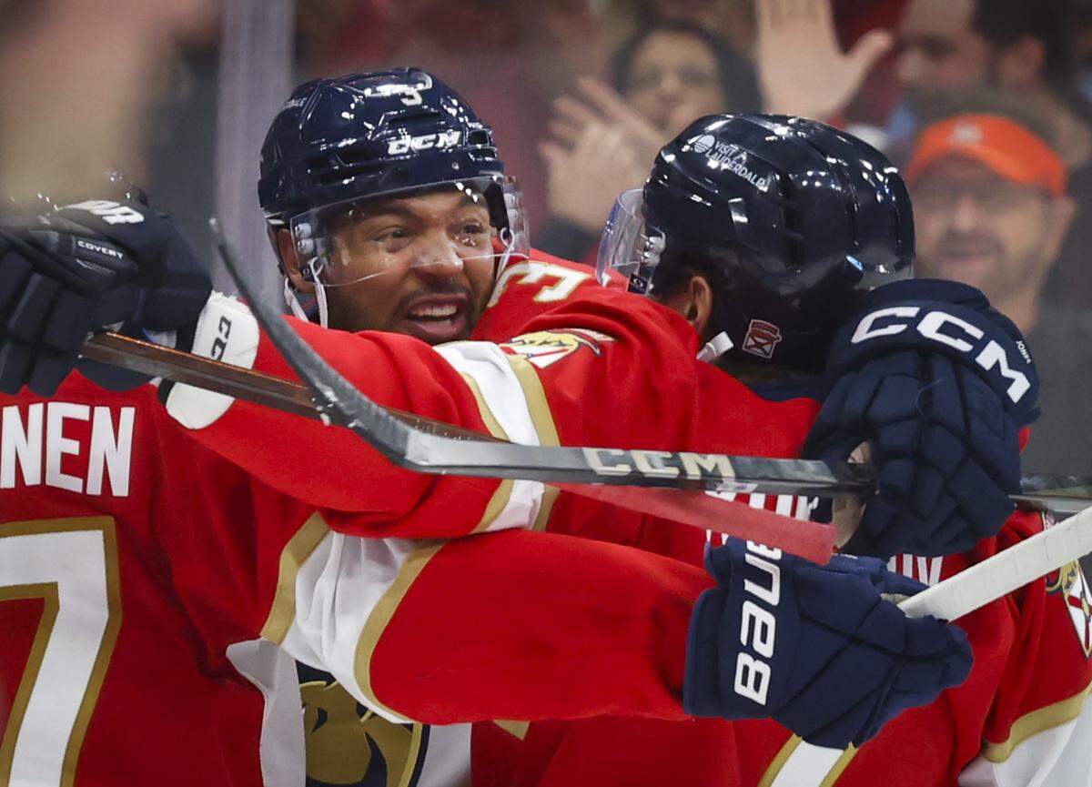 Florida Panthers defenseman Seth Jones (3) gets a group hug after scoring a goal during the third period of Game 4 of the first-round Stanley Cup playoff series against the Tampa Bay Lightning on Monday, April 28, 2025, at Amerant Bank Arena in Sunrise, Fla. The Panthers won 4-2.
