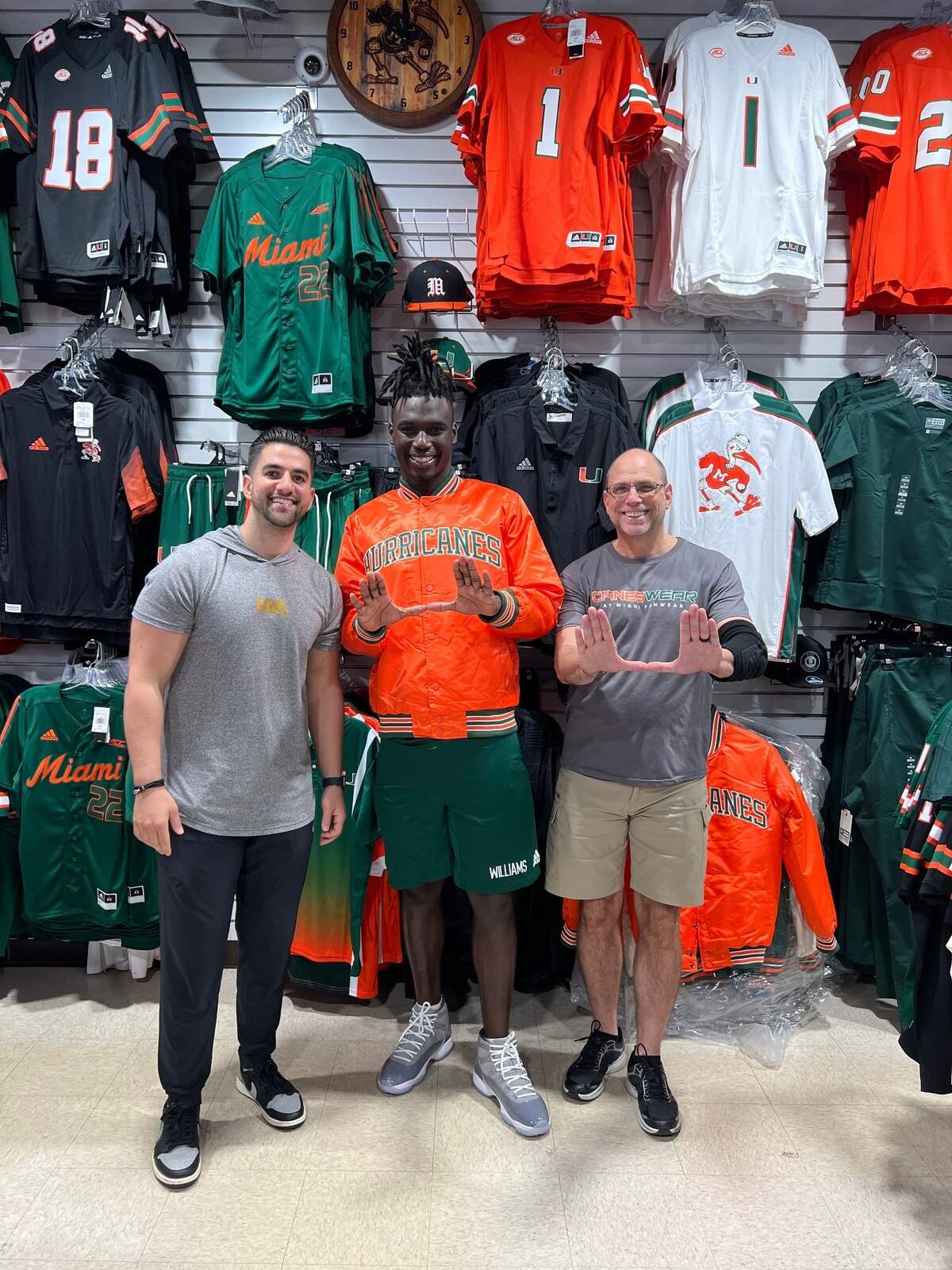 LAA director of marketing Eric Dounn (left) is shown with UM safety James Williams and CanesWear owner Brett Gittelman.