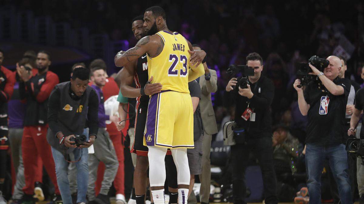 Los Angeles Lakers forward LeBron James (23) hugs ex teammate and current Miami Heat player Dwyane Wade during the first half of an NBA basketball game Monday, Dec. 10, 2018, in Los Angeles.
