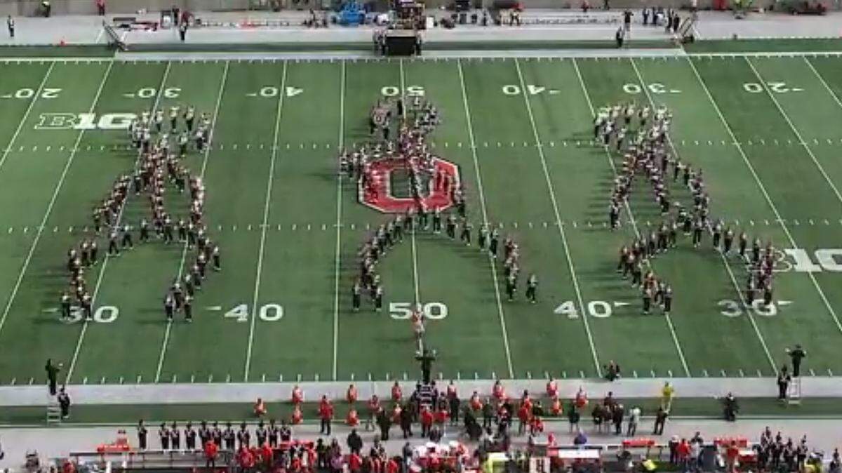 Ohio State’s marching band performs the floss dance move popularized by the backpack kid during halftime of its football game.