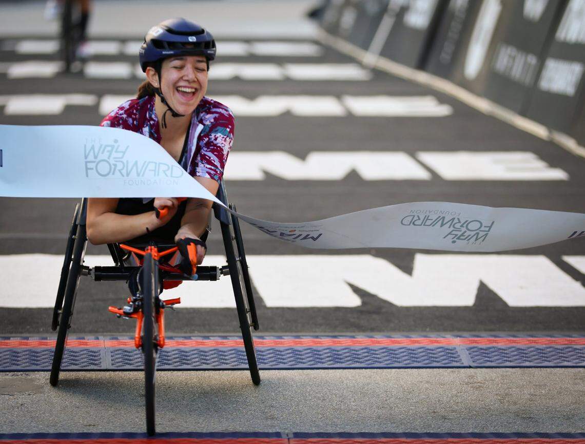 Emi Perry, smiles while crossing the finishing line (first female Marathon Race Chair) as over 18,000 athletes and runners participated in the 2025 Life Time Miami Marathon and Half on February 2, 2024, in downtown Miami, Florida.