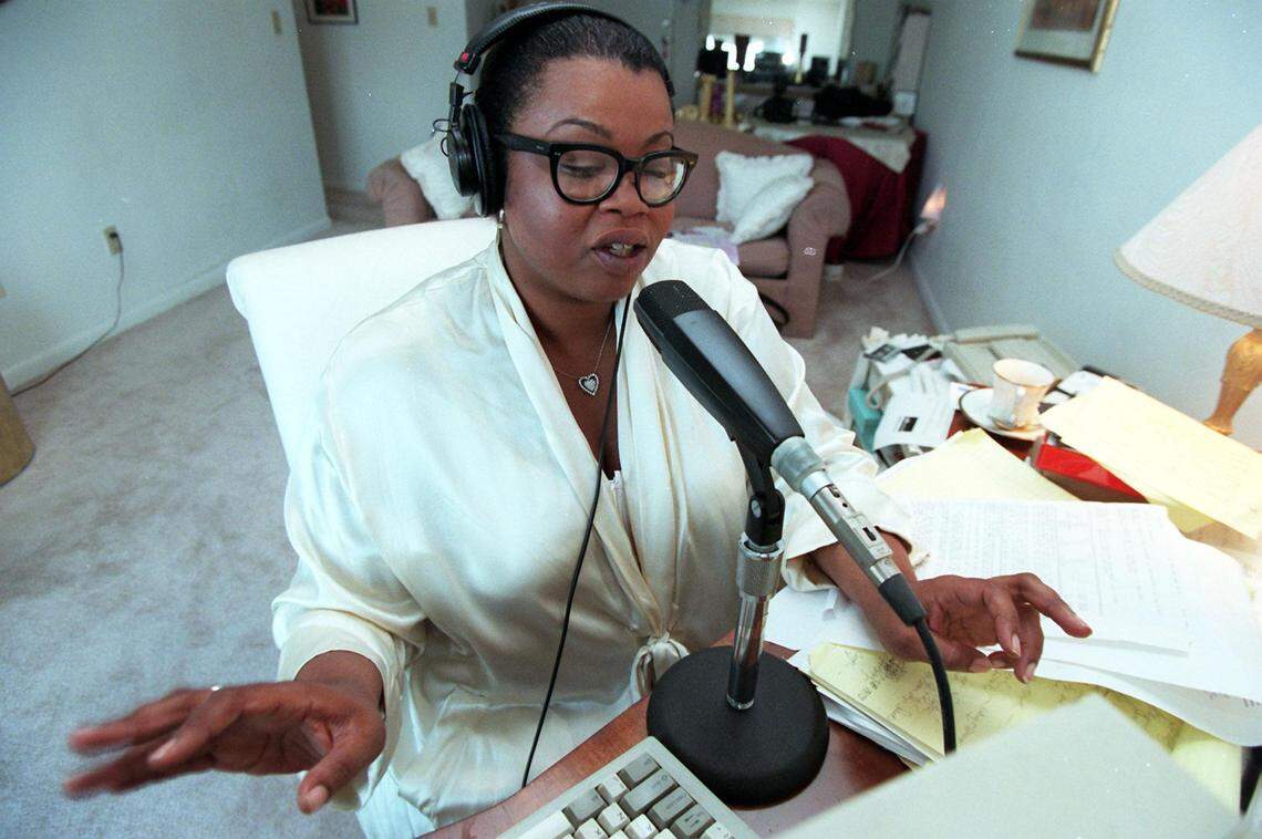 Jill Tracey does her morning show from her apartment on the beach for the Hot105 morning show in March 1997. Tracey died Friday, Nov. 1. She was 60.