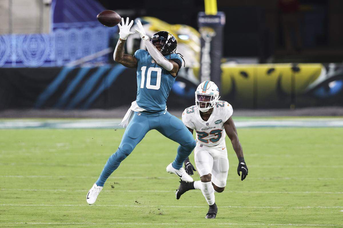 JACKSONVILLE, FLORIDA - SEPTEMBER 24: Laviska Shenault Jr. #10 of the Jacksonville Jaguars catches a pass against Noah Igbinoghene #23 of the Miami Dolphins during the first quarter of a game at TIAA Bank Field on September 24, 2020 in Jacksonville, Florida. (Photo by James Gilbert/Getty Images)
