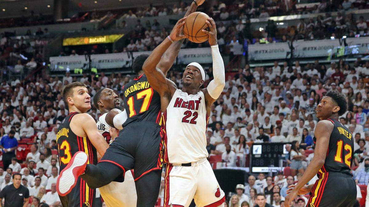 Miami Heat forward Jimmy Butler (22) attempts a shot at the basket as Atlanta Hawks forward Onyeka Okongwu (17) defends in the second quarter at the FTX Arena in Miami, Florida on Sunday, April 17, 2022.